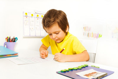 boy write with pencil on the paper